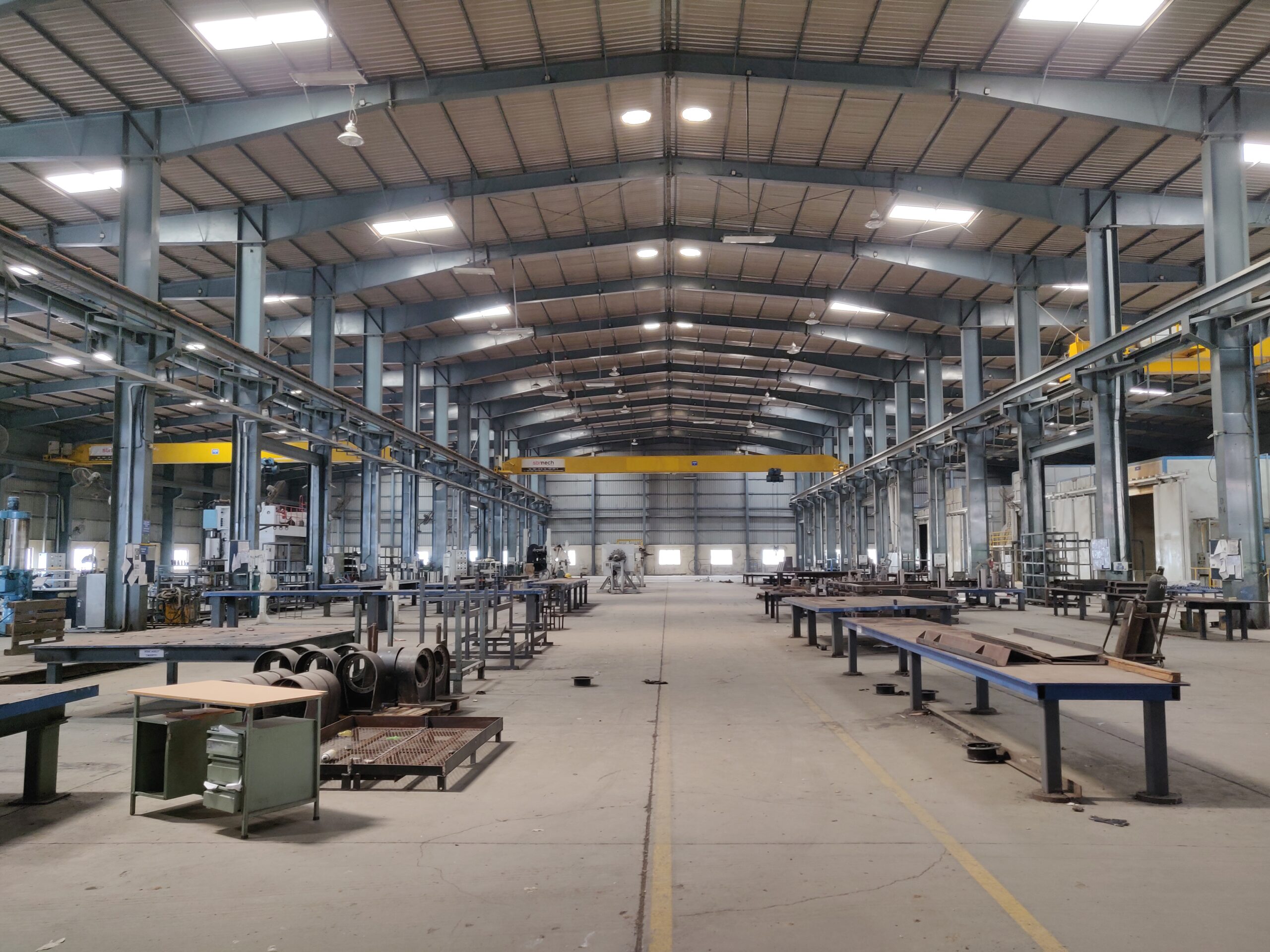 Industrial shed shop floor with dual overhead cranes at a CIPL facility